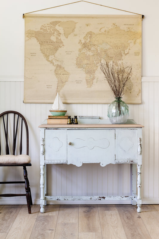 Vintage-style refinished sideboard with world map on the wall- Parlour Homestead House Milk Paint renovation project