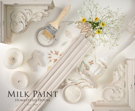 Decorative elements including a brush, candles, and flowers on a white surface with 'Gustavian White Paint Homestead House' branding.