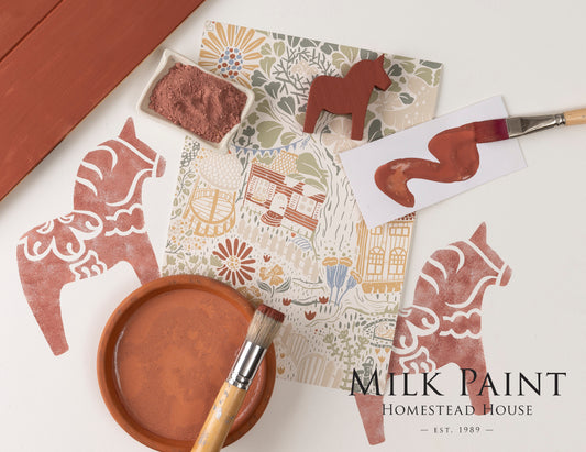 Milk paint with stencils and brushes on a white surface, featuring 'Homestead House' branding.
