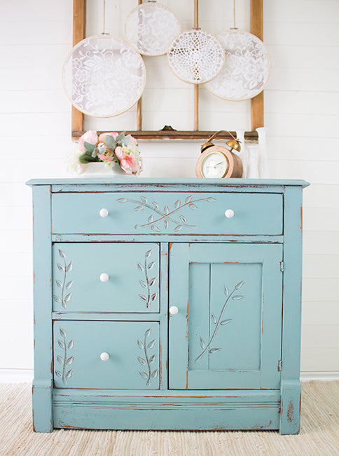 Chucky pale blue duck egg Loyalist milk paint painted cupoard with distressing ageing to engraved leaf design