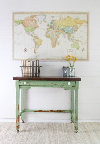 Vintage-style desk with world map on the wall