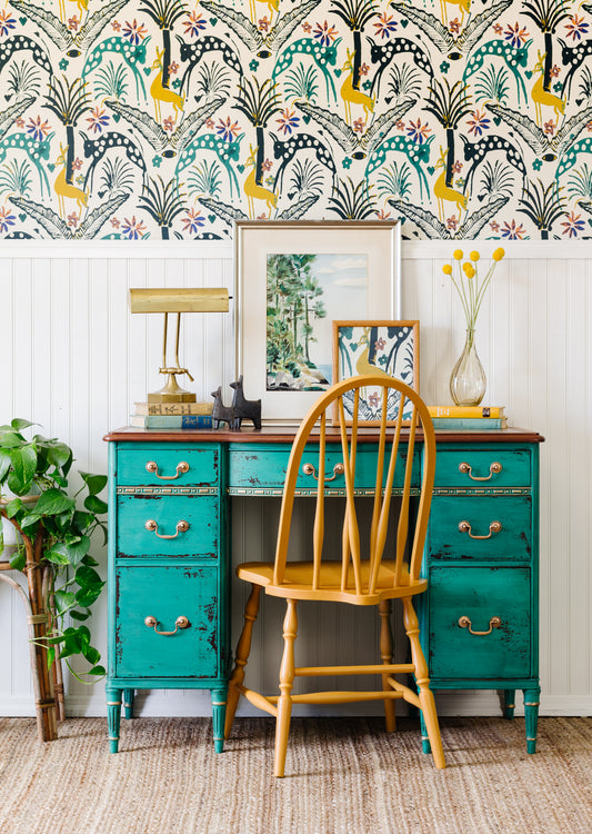 Teal chippy paint desk with yellow chair against a colorful wallpapered wall - Montclair Homestead House Milk Paint