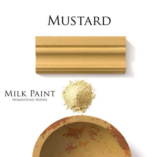 Mustard-colored homestead House milk paint with a chippy wooden bowl, powder, and applied sample on a white background.