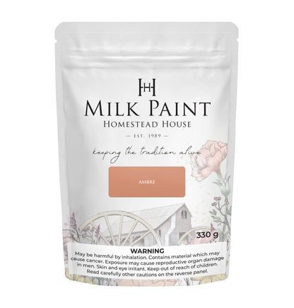 Packaging of Ambre Homestead House Milk Paint with floral design and text on a white background