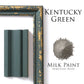 Kentucky Green milk paint sample with a decorative frame and color swatch on a white background.